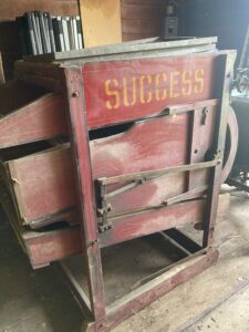 Grain fanning machine, red with "Success" written on it