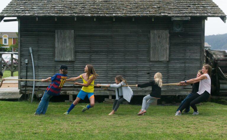 Kids playing tug-of-war in front of the Fire Barn
